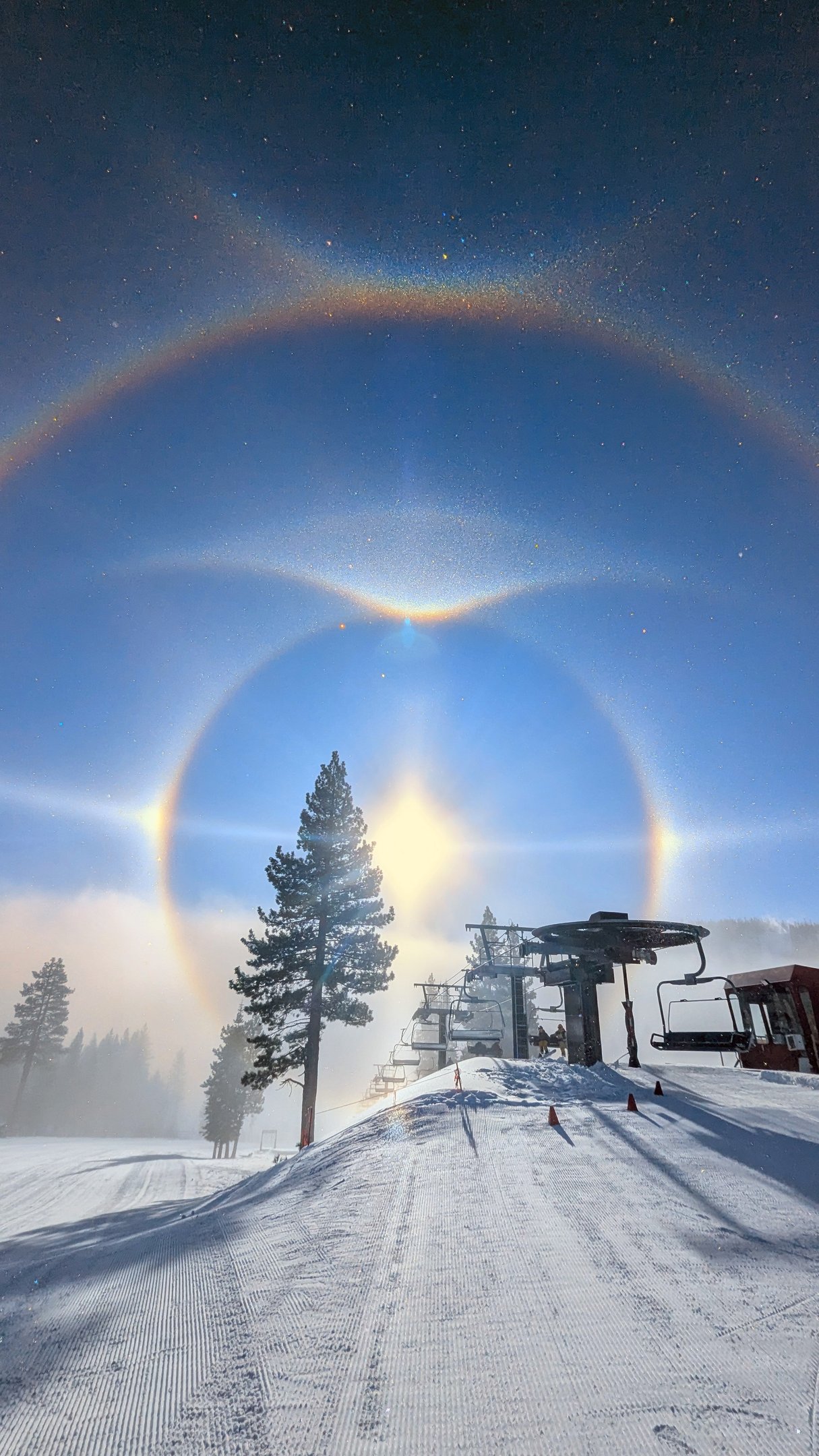 Winter sun dog over Sierra peaks during a morning session